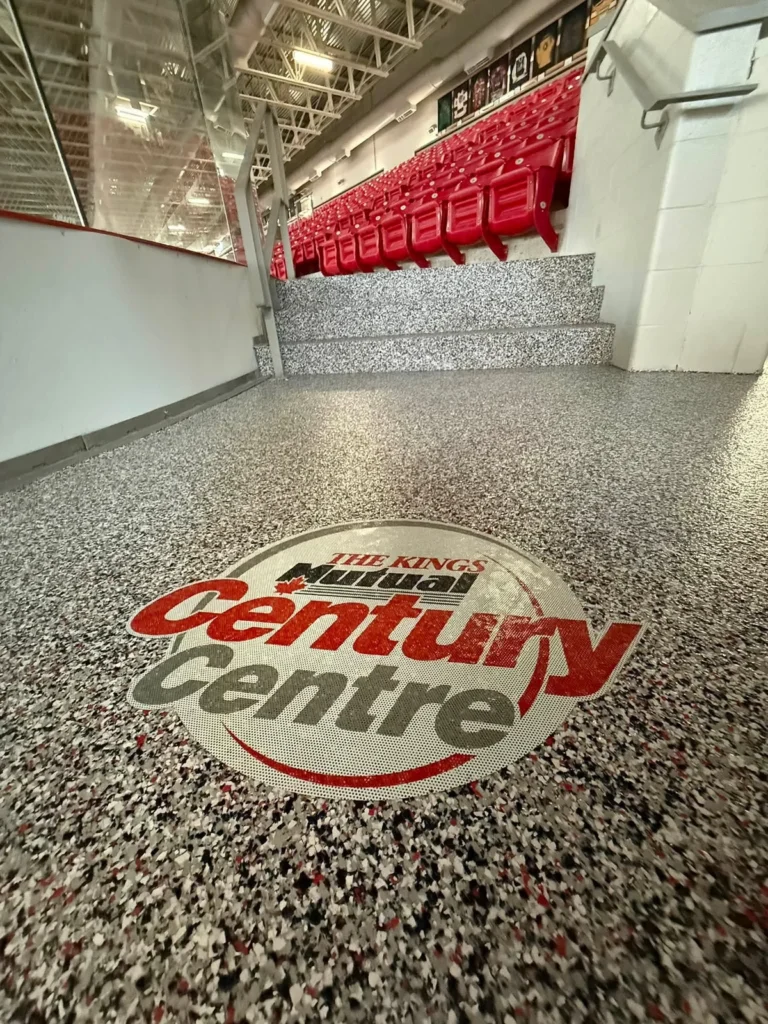 Domino and Cherry flake floor with Kings Mutual Century Centre logo beside arena bleachers in Berwick