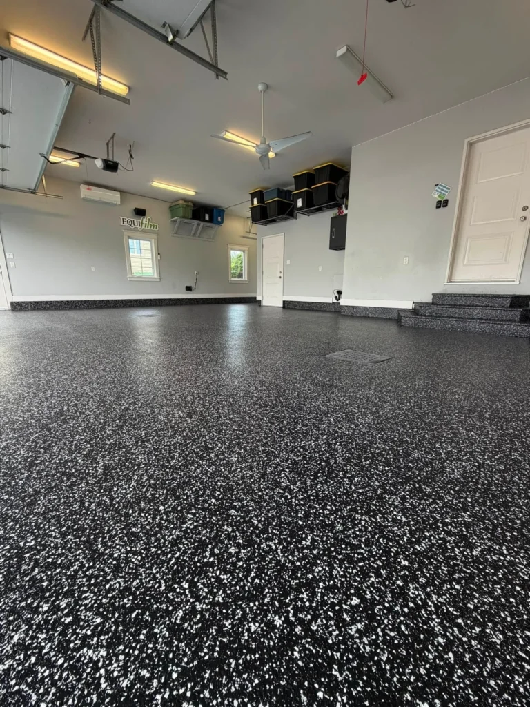 Raven flake garage floor and coated steps in a three-car garage in Dieppe